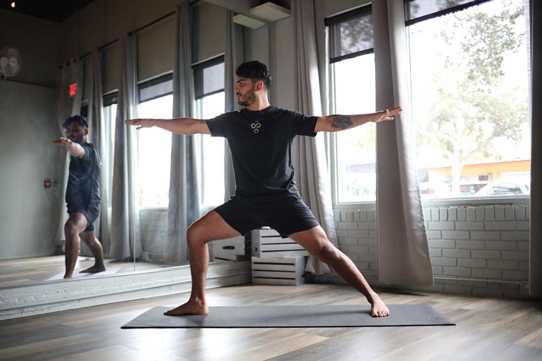 Yoga Teacher, Bryce, demonstrating the Warrior 2 Yoga Pose